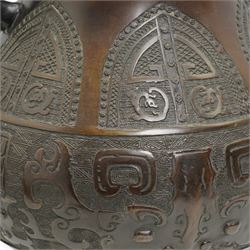 Large Asian bronze Archaic form vase with mask handles, geometric arched panels etc, with character mark to base and later drilled, H34cm