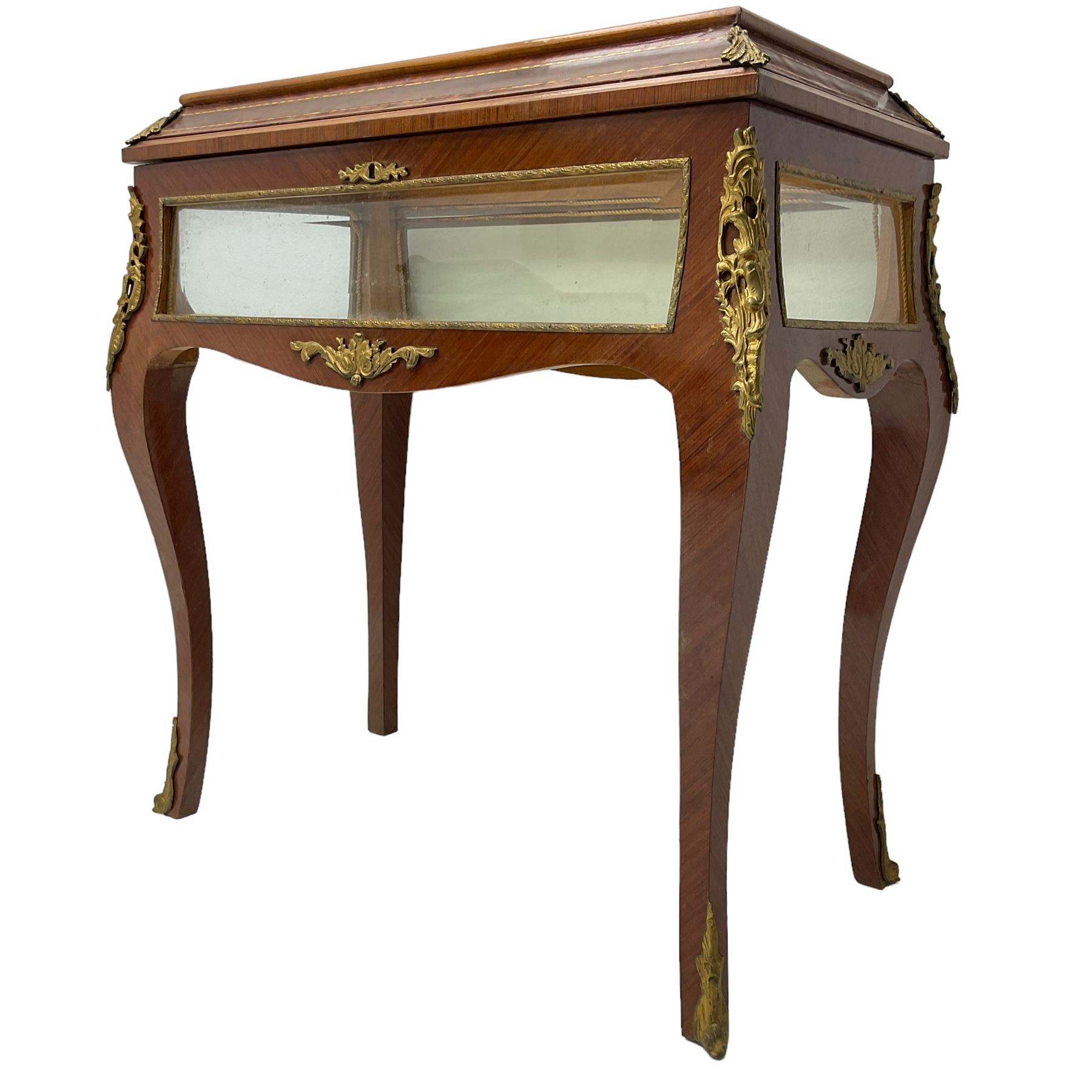 Mid-to-late 20th century French design Kingwood and walnut bijouterie cabinet, enclosed by cavetto moulded hinged lid with gilt metal foliage cast mounts and checkered stringing, on cabriole supports mounted by ornate cartouche castings and scrolled foliate terminal caps, lined in gold foliate pattern fabric and glazed with bevelled glass