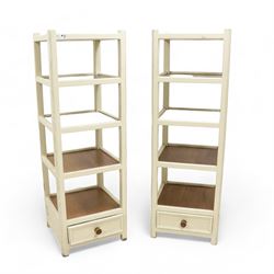 Pair of distressed cream painted and mahogany storage stands, five shelves with drawer to base