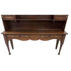 Early 20th century Georgian design oak dresser, projecting cornice with shaped apron over a three-tier plate rack with flanking fielded spice cupboards, the base fitted with three drawers, on turned supports