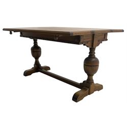 Early 20th century oak 'Ee-zi-Way one motion extending dining table', rectangular top over twin baluster end supports united by stretcher