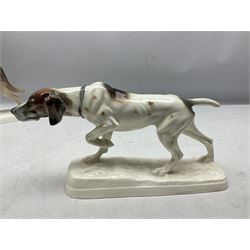 Two Hertwig and Co Katzhutte figures of dogs, comprising a German Shepherd and a pointer dog, both with printed marks beneath, largest H21.5cm W25cm