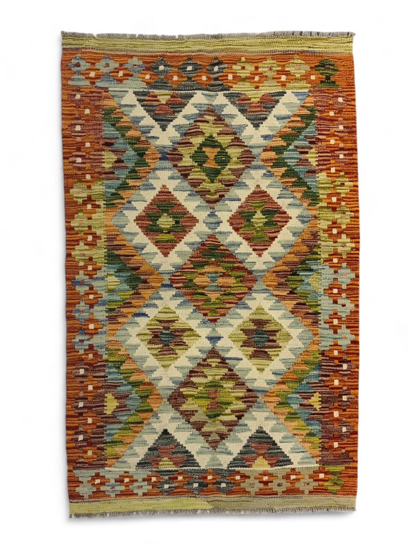 Chobi Kilim multi-coloured rug, the busy field decorated with all-over lozenges of contrasting colour, the guard lines decorated with further geometric designs