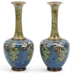 Pair of Royal Doulton stoneware bottle vases, decorated with bunches of grapes, inscribed E.B, impressed 8460, H26cm 