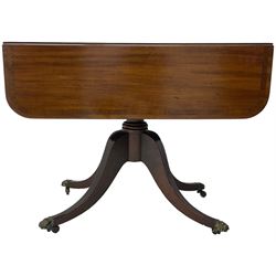 Early 19th century mahogany supper table, rectangular reed moulded drop-leaf top with rounded corners, fitted with single end drawer, on turned pedestal with four out-splayed supports with brass paw castors 