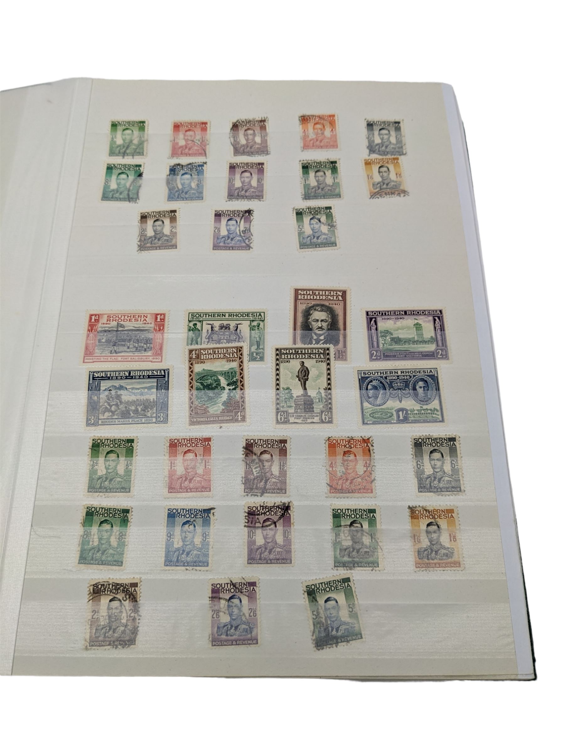 Mostly Commonwealth or Empire stamps including Queen Elizabeth II Northern Rhodesia, Nyasaland, Solomon Islands, Aden, Bermuda, Grenada 'Associated Statehood' overprints, King George VI Falkland Islands Dependencies with values to one shilling etc, mixture of mint and used, housed in a green stockbook