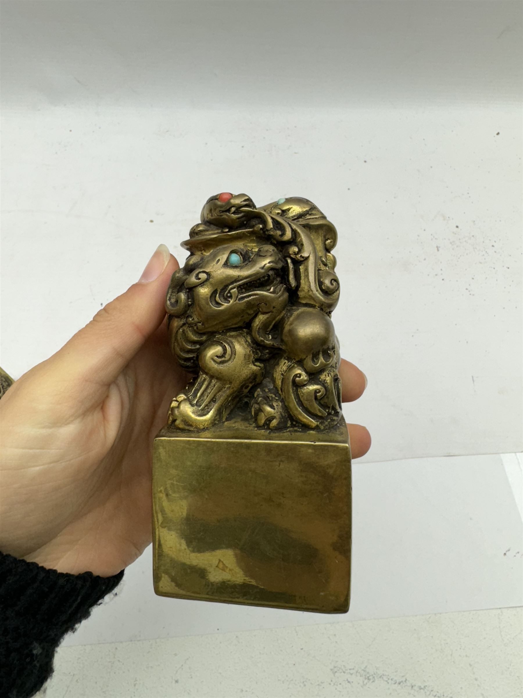 Two contemporary Chinese solid cast brass dragon desk seal, set with turquoise and coral eyes