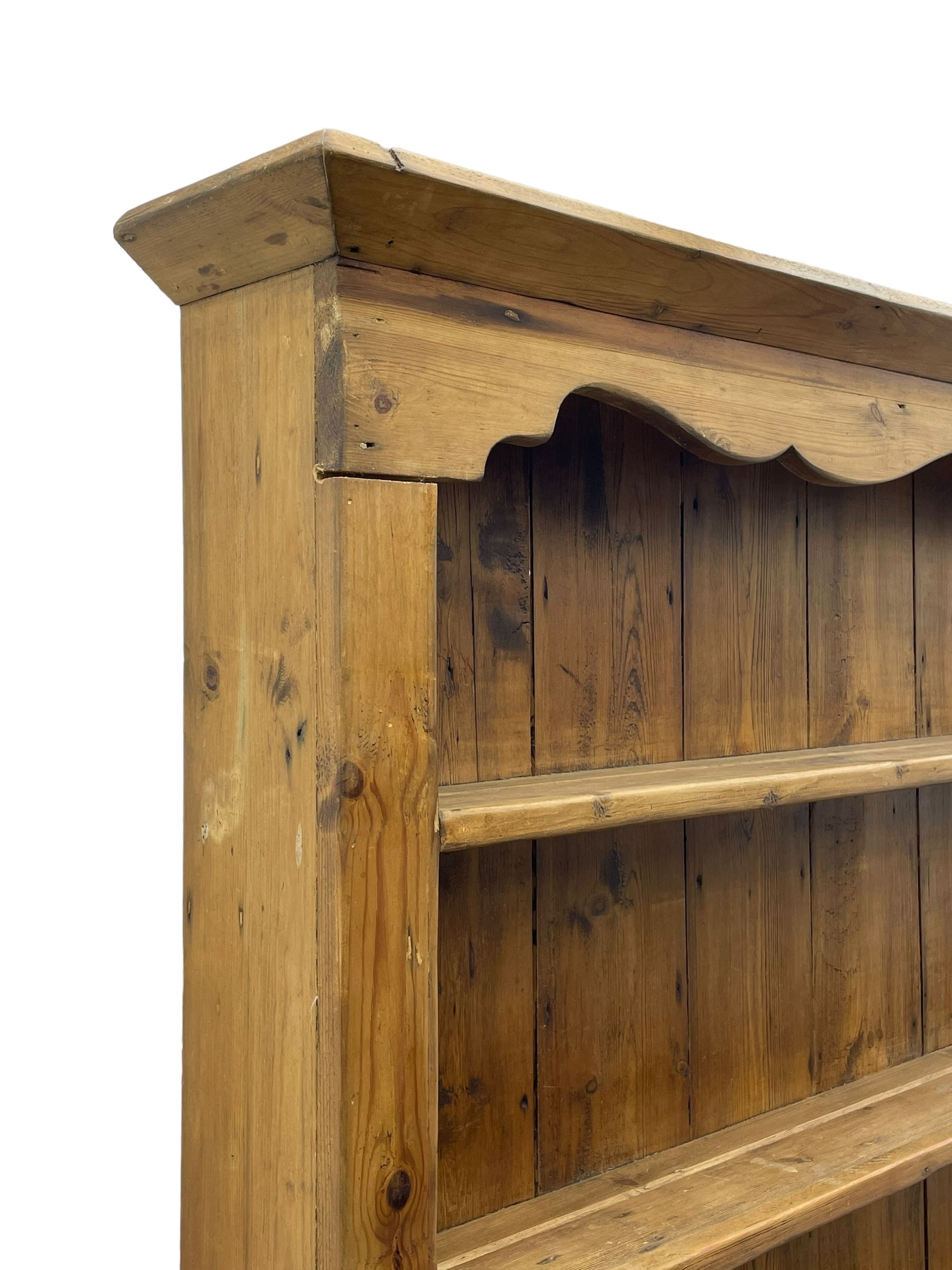 Waxed pine 'chicken coop' or 'hutch' dresser, projecting cornice over shaped frieze and three tier plate rack, the stepped waterfall lower section fitted with two slatted chicken coops, on sledge feet 