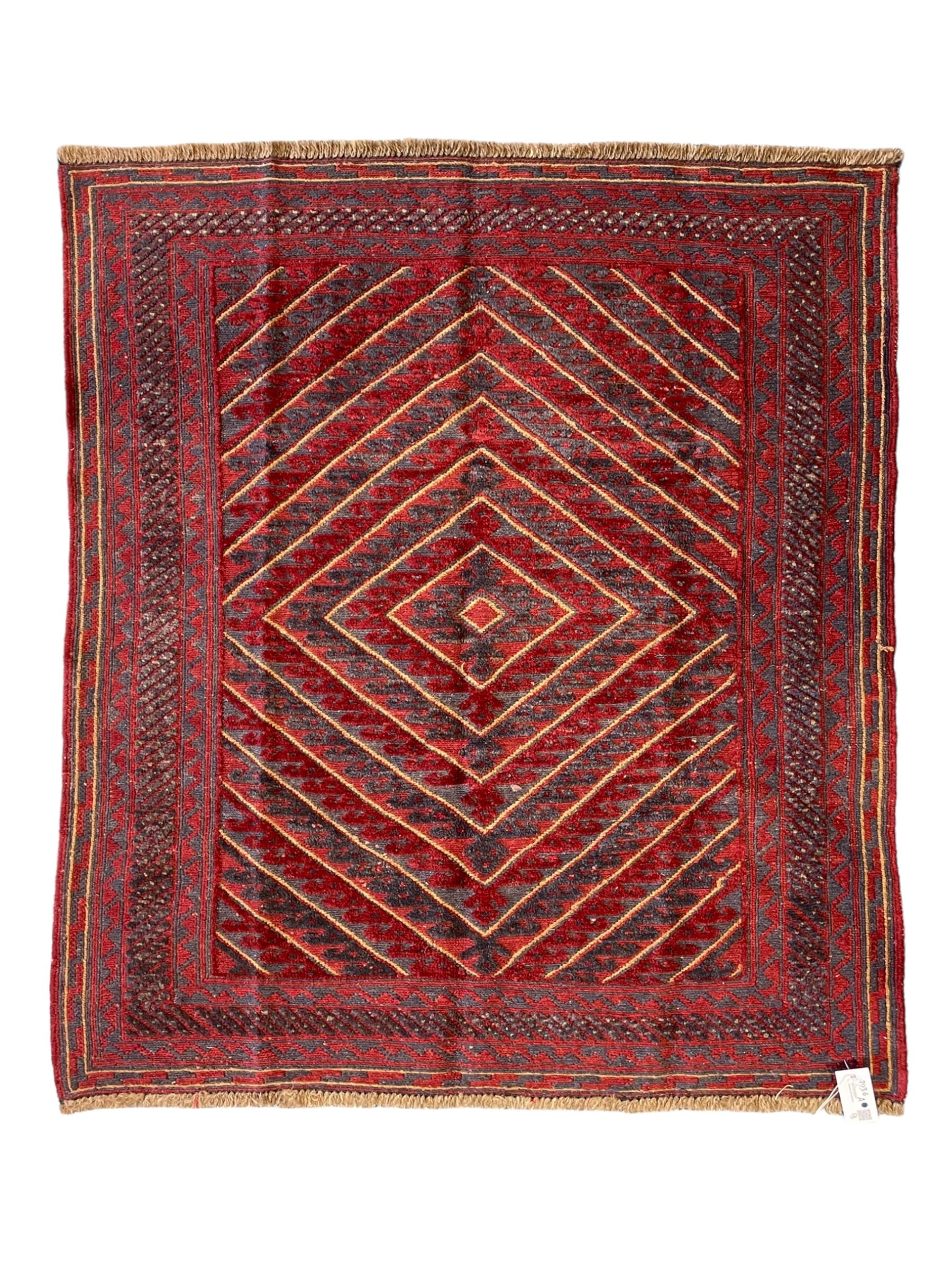 Meshwani indigo and maroon ground rug, the field decorated with a central lozenge with concentric borders containing hook motifs, enclosed by geometric zig-zag guard lines