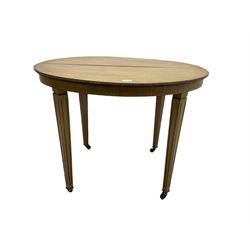 Edwardian mahogany and satinwood banded oval table, on square tapering fluted supports with brass and ceramic castors