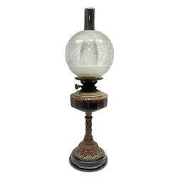 Victorian oil lamp, the faceted reservoir upon embossed copper stem and stepped circular ceramic base, with etched floral glass shade