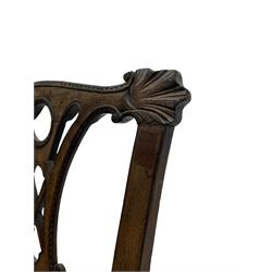 Unusual 18th century mahogany elbow chair, the shaped cresting rail with projecting shell carved ears, pierced and scroll carved splat over drop-in upholstered seat, shaped arms with ball and claw carved terminals, the seat rails carved with shell cartouches, on foliate carved cabriole supports with ball and claw feet 