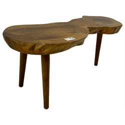 Mid-20th century live edge walnut coffee table, the top showcases the natural grain and organic form of the wood, supported by three tapered legs 