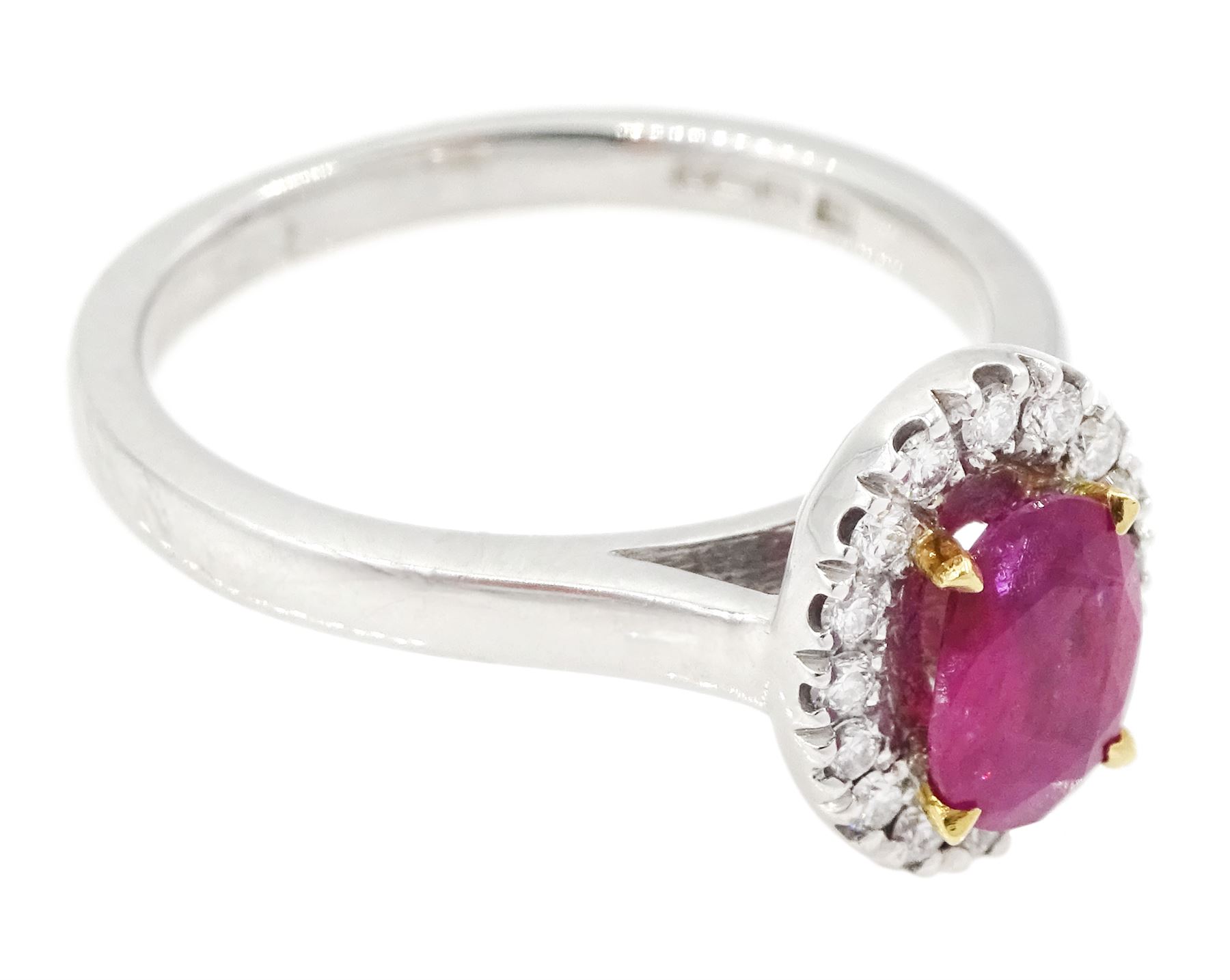 18ct white gold oval cut ruby and round brilliant cut diamond cluster ring, hallmarked, ruby approx 0.85 carat, total diamond weight approx 0.15 carat