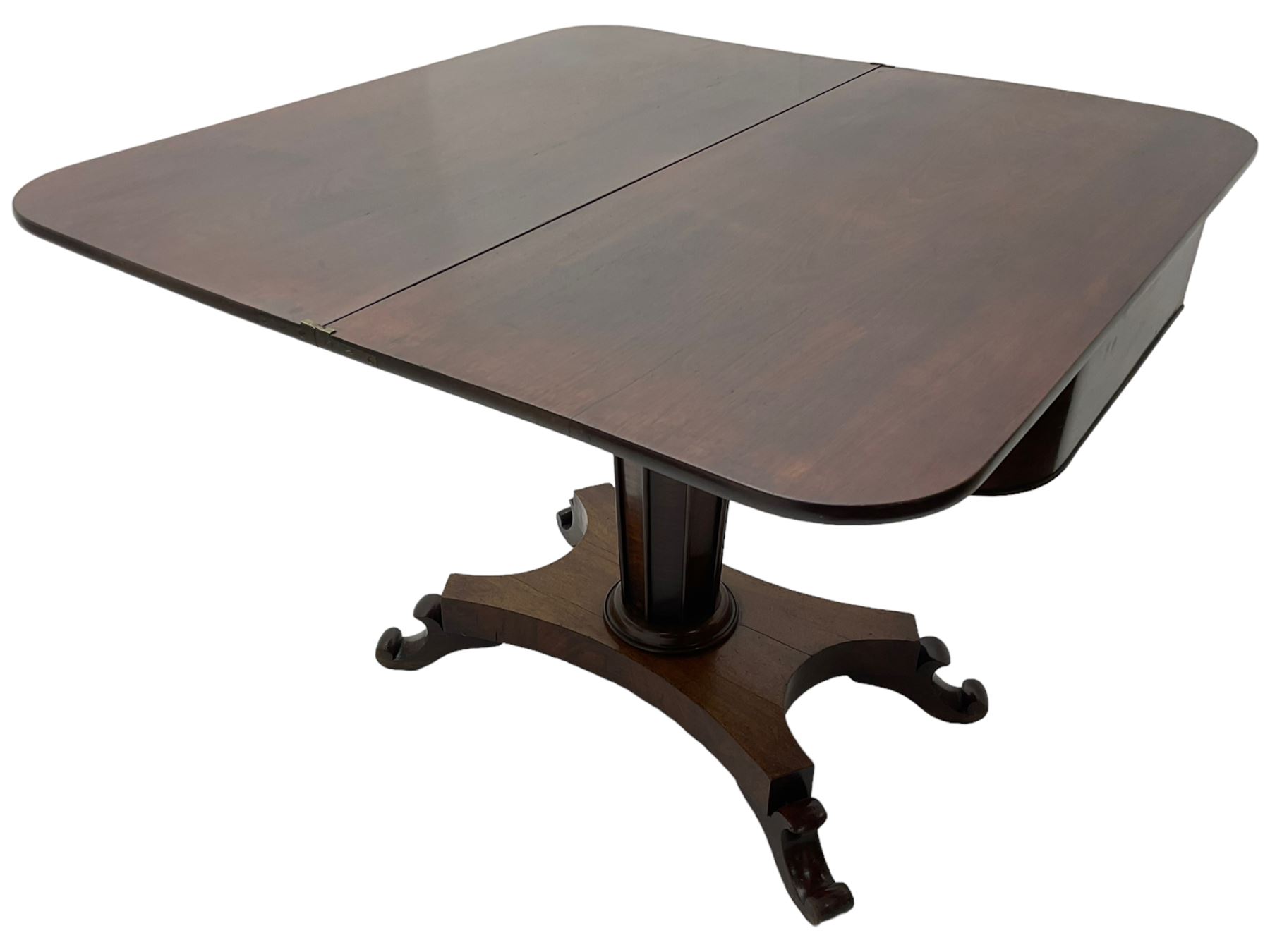 William IV mahogany tea table, rectangular fold-over top over banded frieze, tapering pedestal base with moulded vertical rails, on quadruform base with C-scroll feet