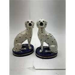 Pair of Staffordshire figures modelled as chained Dalmatians seated upon cobalt blue oval bases, H13cm, together with a Staffordshire pastille burner modelled as a castle, H12cm, a pair of 19th century Derby potpourri pots (lacking covers), and an 18th century blue and white tea bowl 