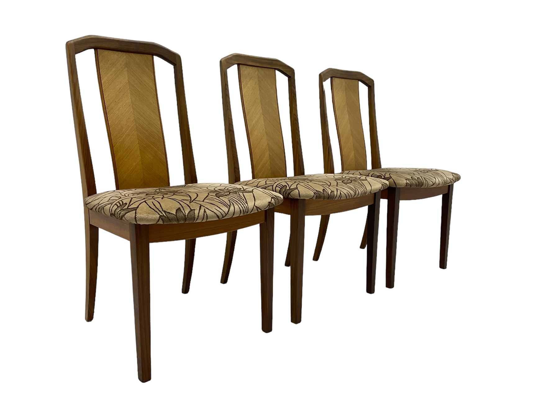 G-Plan -  1970s teak extending dining table, pull-out extending action with fold-out leaf, rectangular end supports on sledge feet united by stretcher (100cm x 160cm - 205cm, H73cm); set of six dining chairs, chevron-patterned backrests upholstered with floral patterned fabric, on tapered legs, H89cm