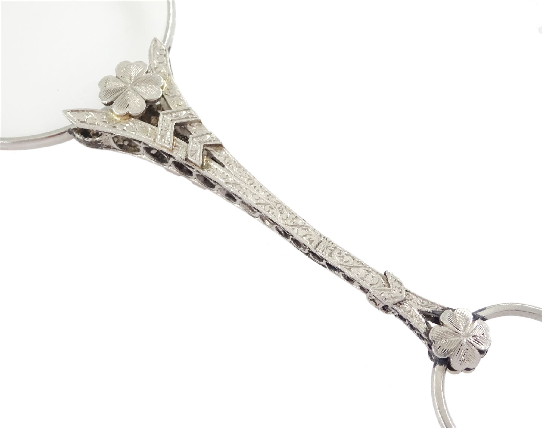 Early 20th century platinum and diamond lorgnette, the milgrain set rose cut diamond handle, with flower head terminals, the reverse with engraved foliate decoration, to spring-loaded glass lenses