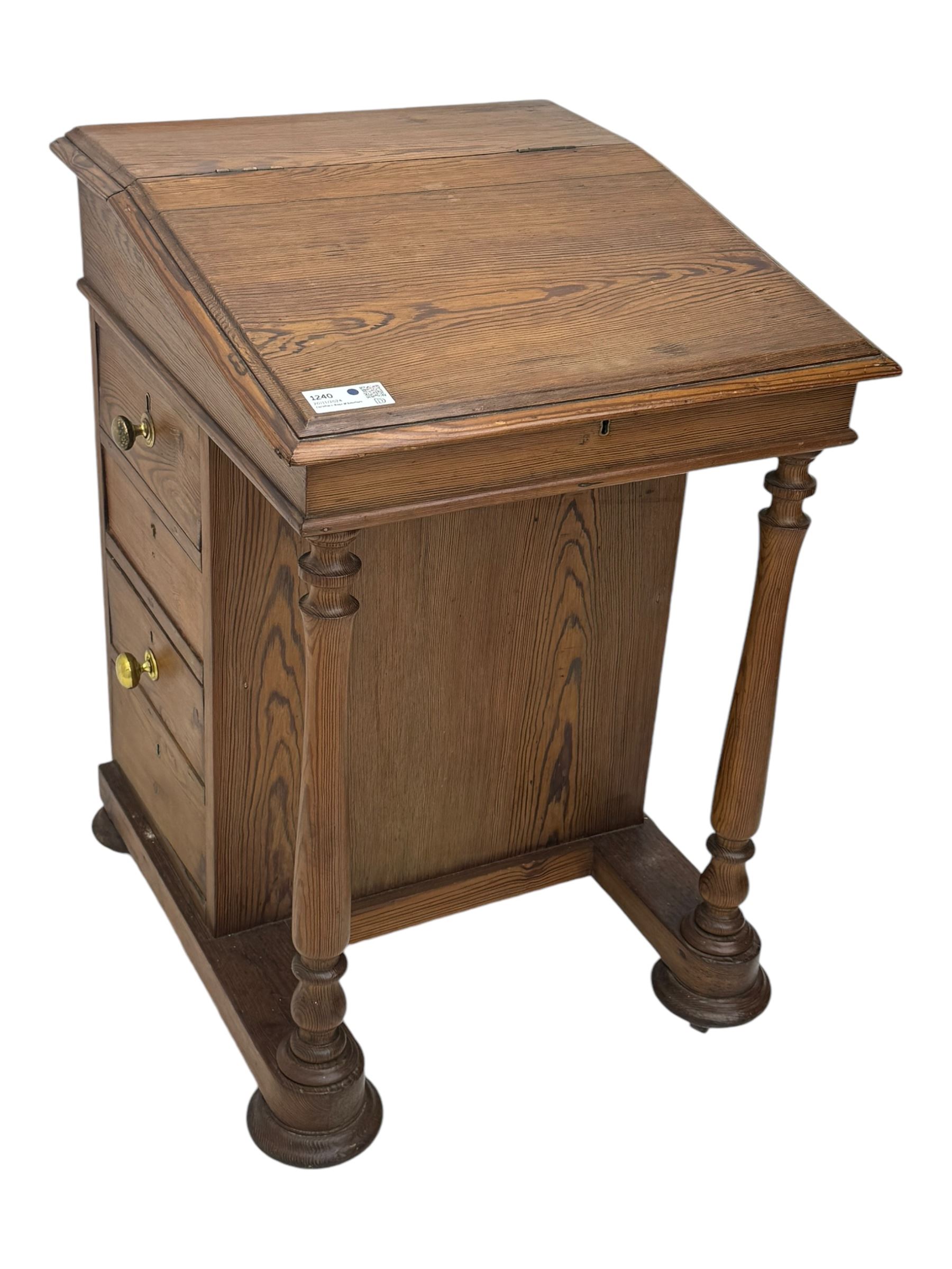 19th century pitch pine Davenport desk, sloping hinged top, fitted with four drawers, on turned column supports, turned compressed feet with castors 