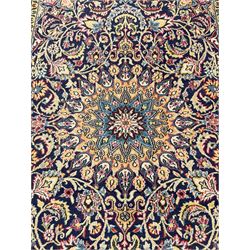 Persian indigo ground rug, overall arabesque design, central multi-point medallion surrounded by scrolling leafy branches and palmettes, the border decorated with repeating stylised plant motifs within guard stripes 