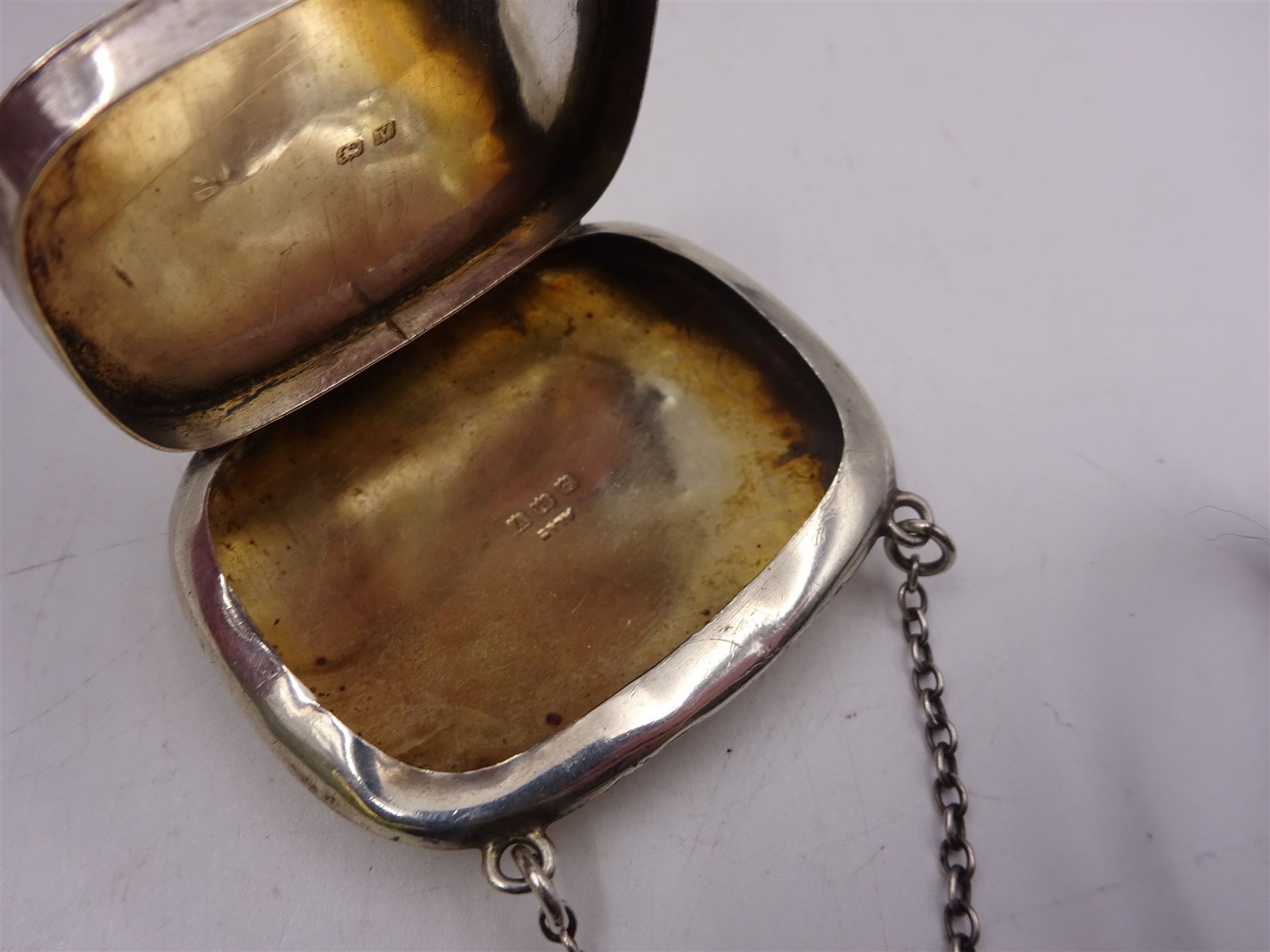 1920s silver miniature purse, engraved with triskelion symbol to hinged cover, hallmarked Adie & Lovekin Ltd, Birmingham 1920, together with five early 20th century silver vesta cases, all of typical form, engraved with foliate and scrolling details, all hallmarked