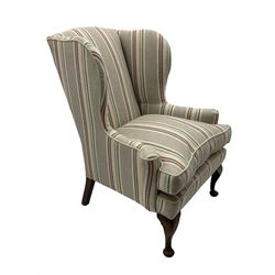 Georgian design hardwood-framed wingback armchair, curved wingback terminating to curved and rolled arms, upholstered in striped fabric with loose seat cushion, on cabriole front feet 