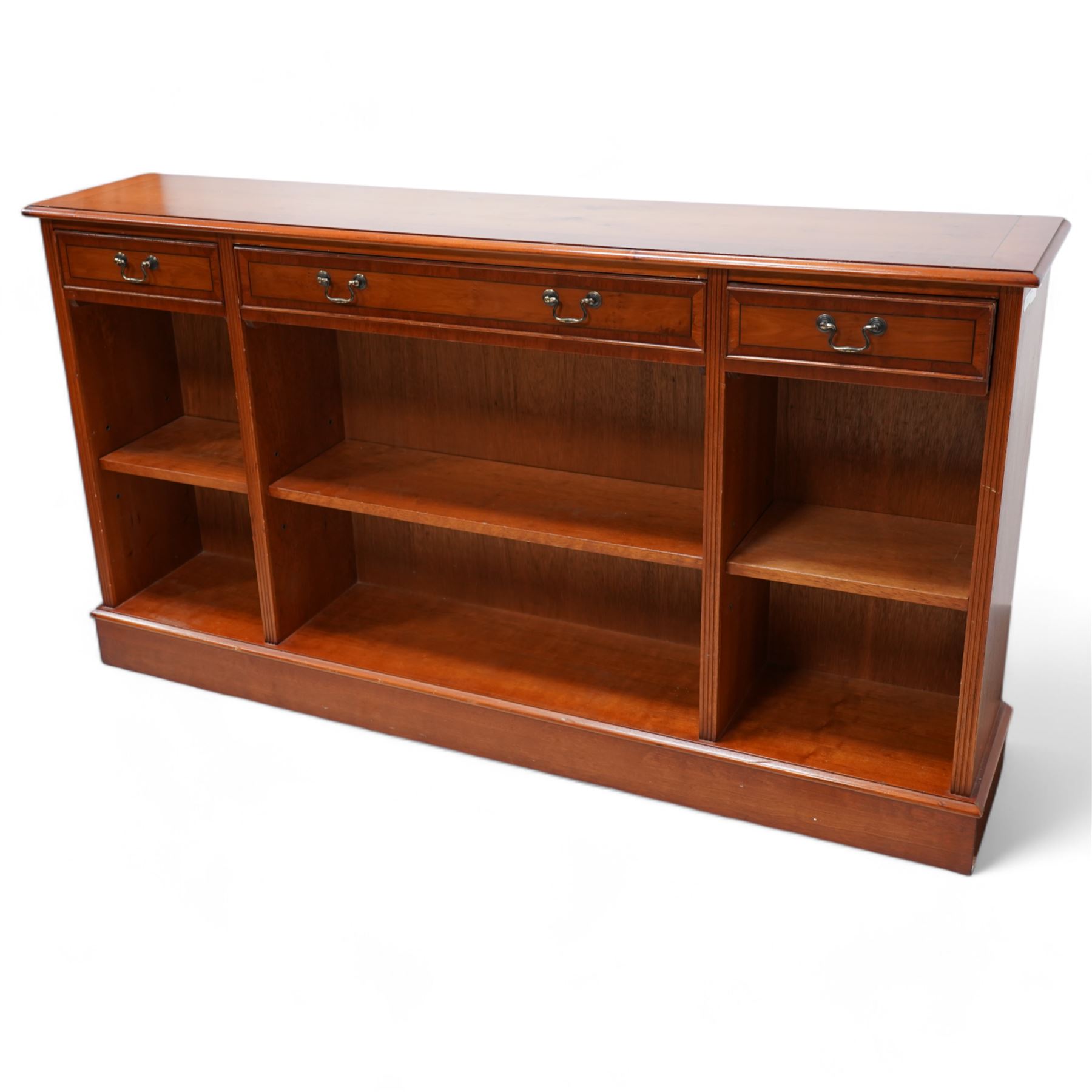 Georgian design yew wood open bookcase, fitted with three drawers above three open shelves, flanked by fluted uprights