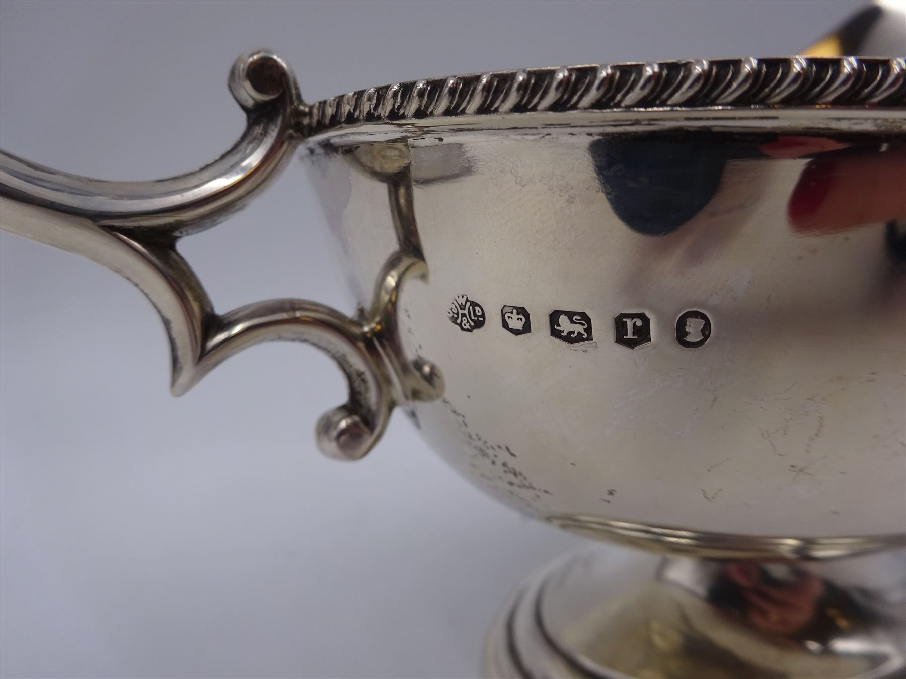 1930s silver sauce boat, of typical form, with oblique gadrooned rim and acanthus capped flying C scroll handle, by William Hutton & Sons Ltd, Sheffield 1934, H11cm