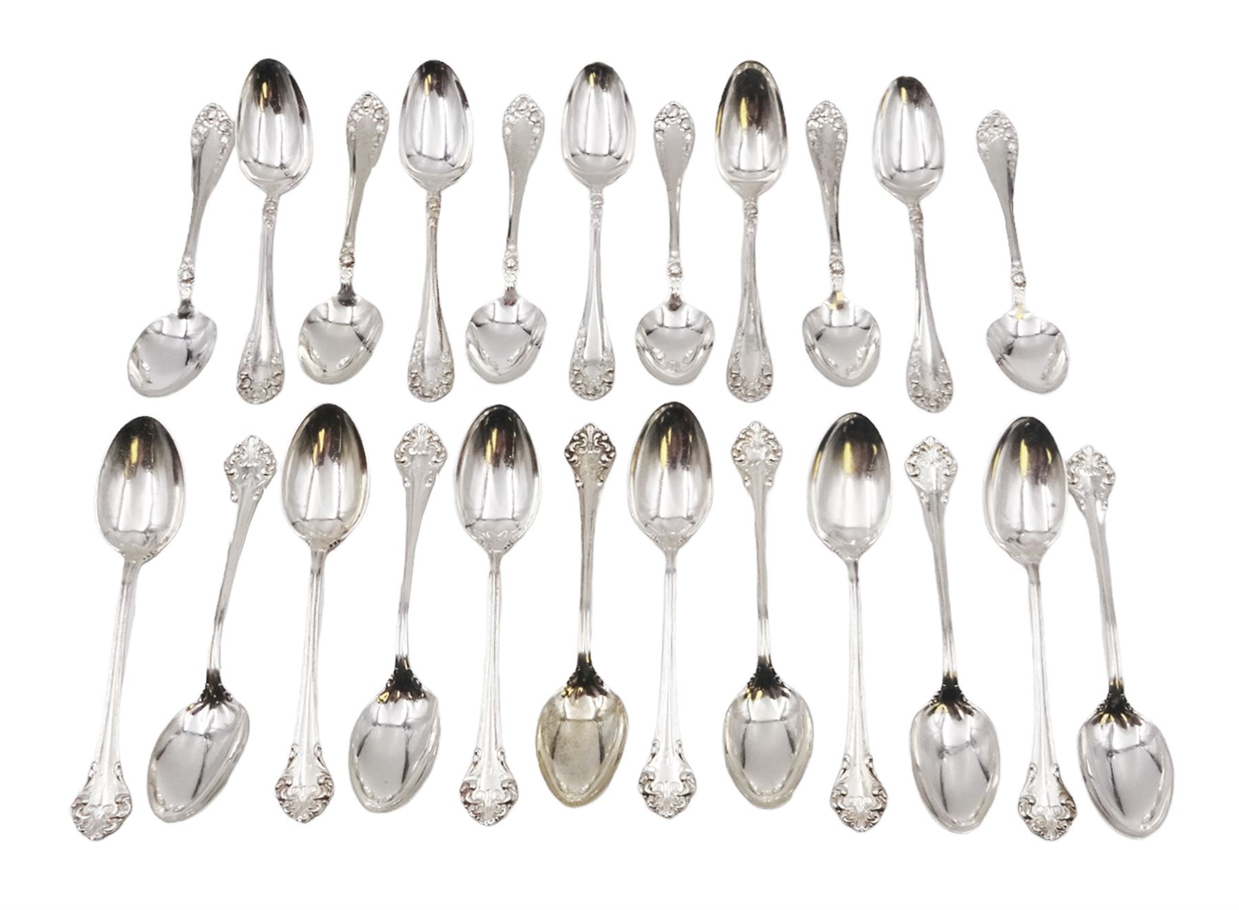 Two sets of twelve late 19th/ early 20th century American silver coffee spoons, the first set with engraved initial to terminal within scrolling border and engraved date verso, the second set with embossed floral decoration to handles, all stamped Sterling 