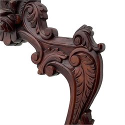 Pair of carved hardwood wall mirrors, shaped floral carved pediment over trailing and scrolled foliage decoration, plain mirror plate 