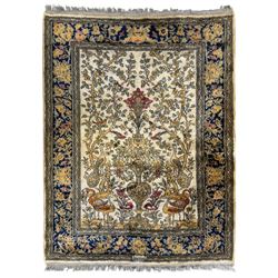 Persian ivory ground silk rug, central field decorated with symmetrical tree of life motif...