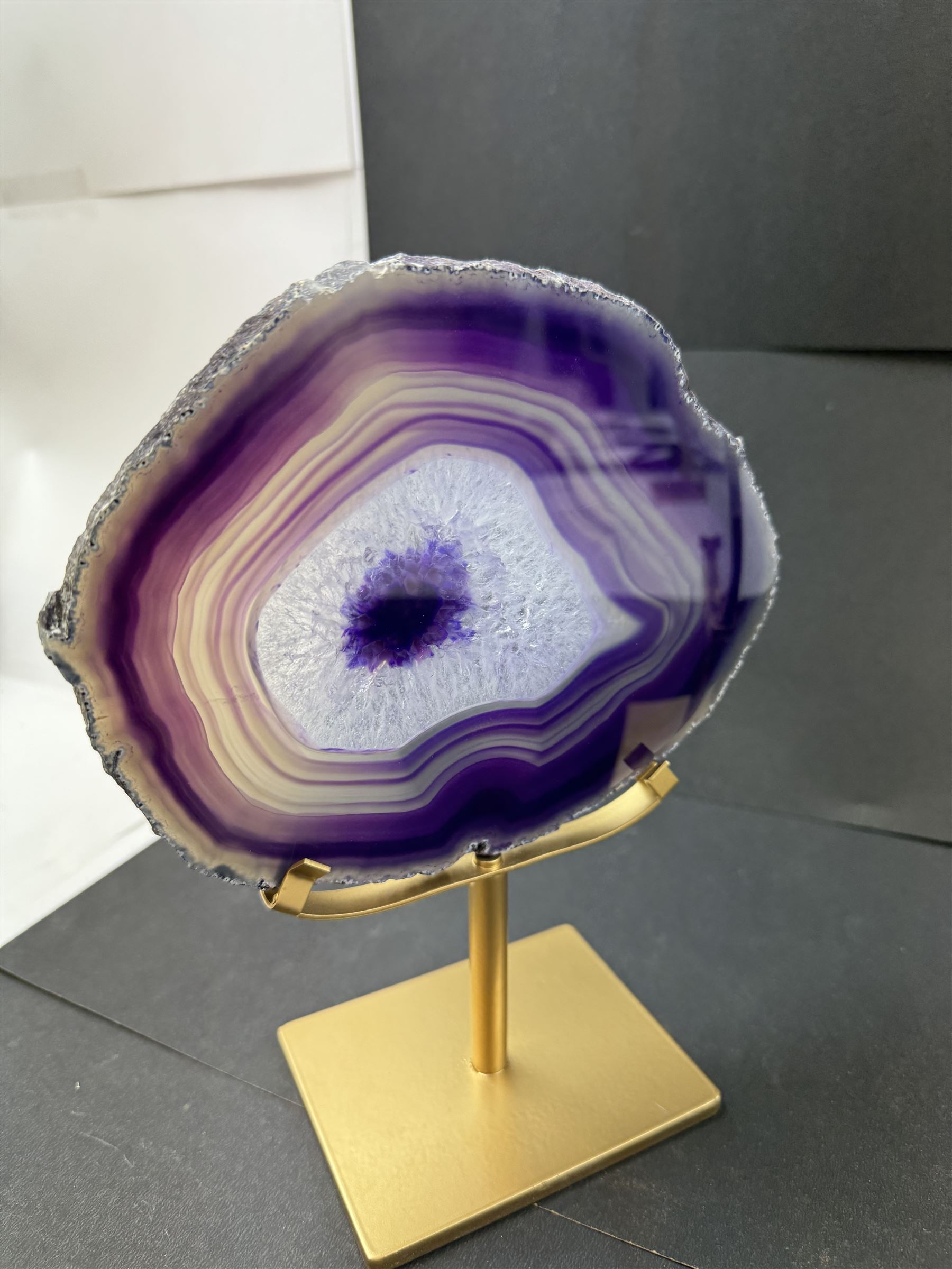 Pair of purple agate slices, polished with rough edges, raised upon gilt metal stands, H22cm