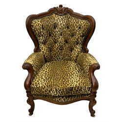 Pair of Victorian design stained beech armchairs, upholstered in leopard print fabric, with carved top rail over button-tufted backrest, scroll arms, serpentine front rail, raised on cariole supports