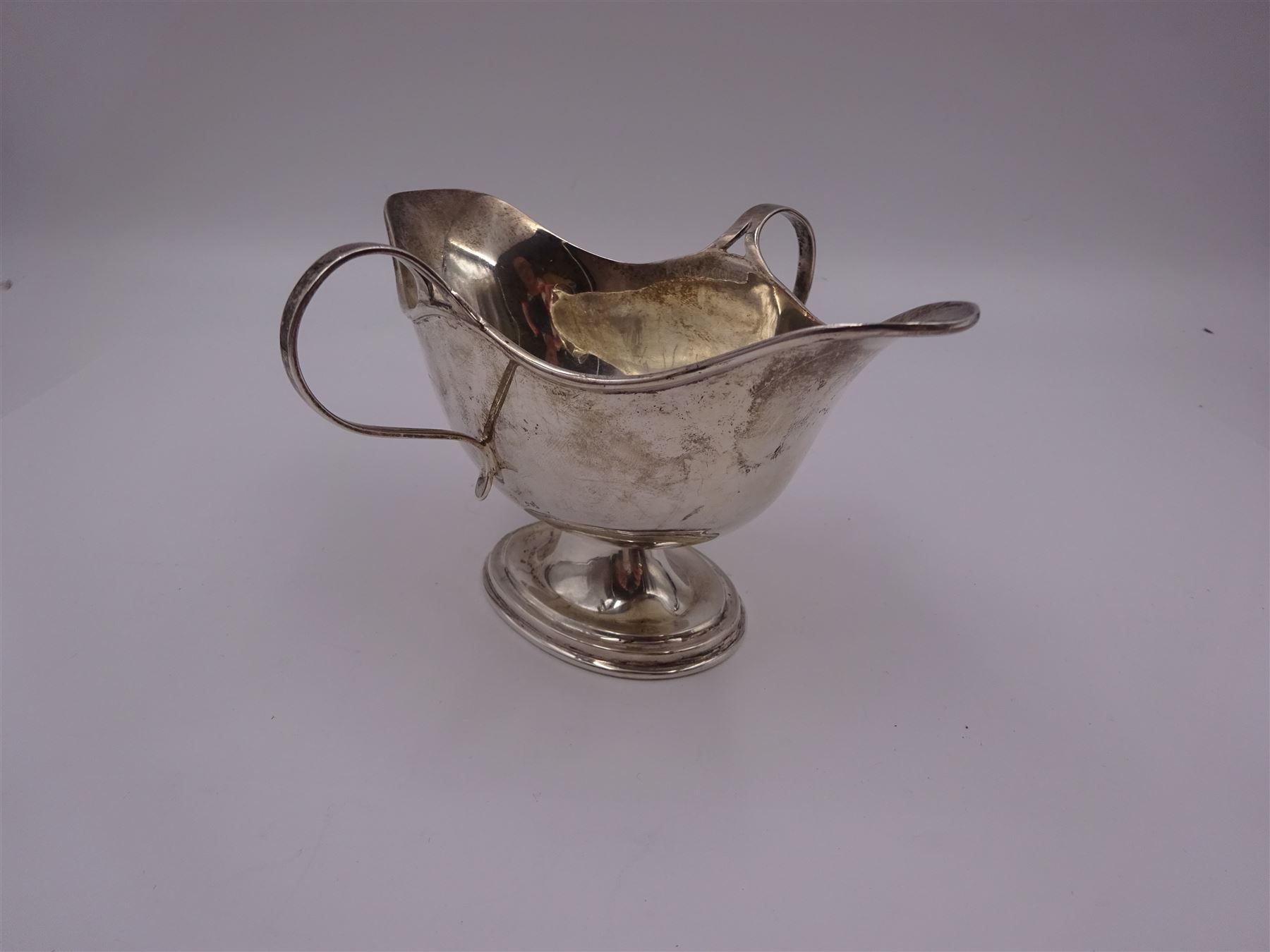 Edwardian silver twin handled pedestal dish, of navette shaped form, with twin loop handles, upon a stepped oval pedestal, hallmarked William Neale, Birmingham 1907, H9cm