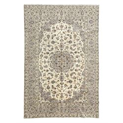 Persian Kashan ivory ground carpet, floral central medallion surrounded by trailing leafy ...