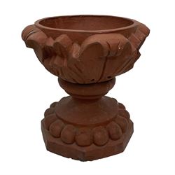 Pair of late 19th to early 20th century red terracotta garden urn planters, the shallow bowls moulded with curled acanthus leaf decoration, on circular foot with globular beaded moulding, octagonal base