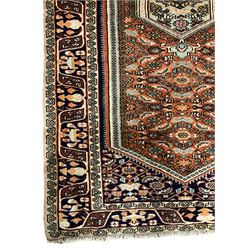 North West Persian Bidjar rug, orange peach ground extended field on indigo ground, decorated with floral Herati motifs, repeating waved border decorated with stylised plant motifs