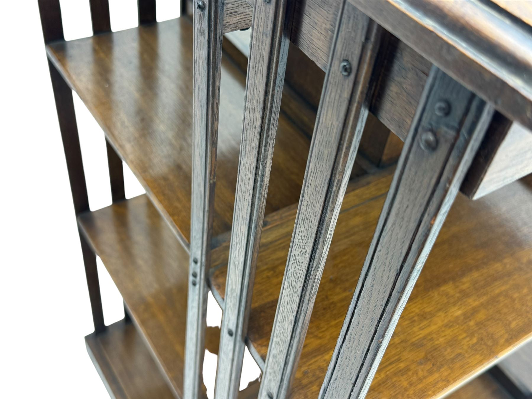 Early 20th century oak revolving bookcase, moulded square top over three tiers, with moulded vertical slats, on four spoke base with castors 