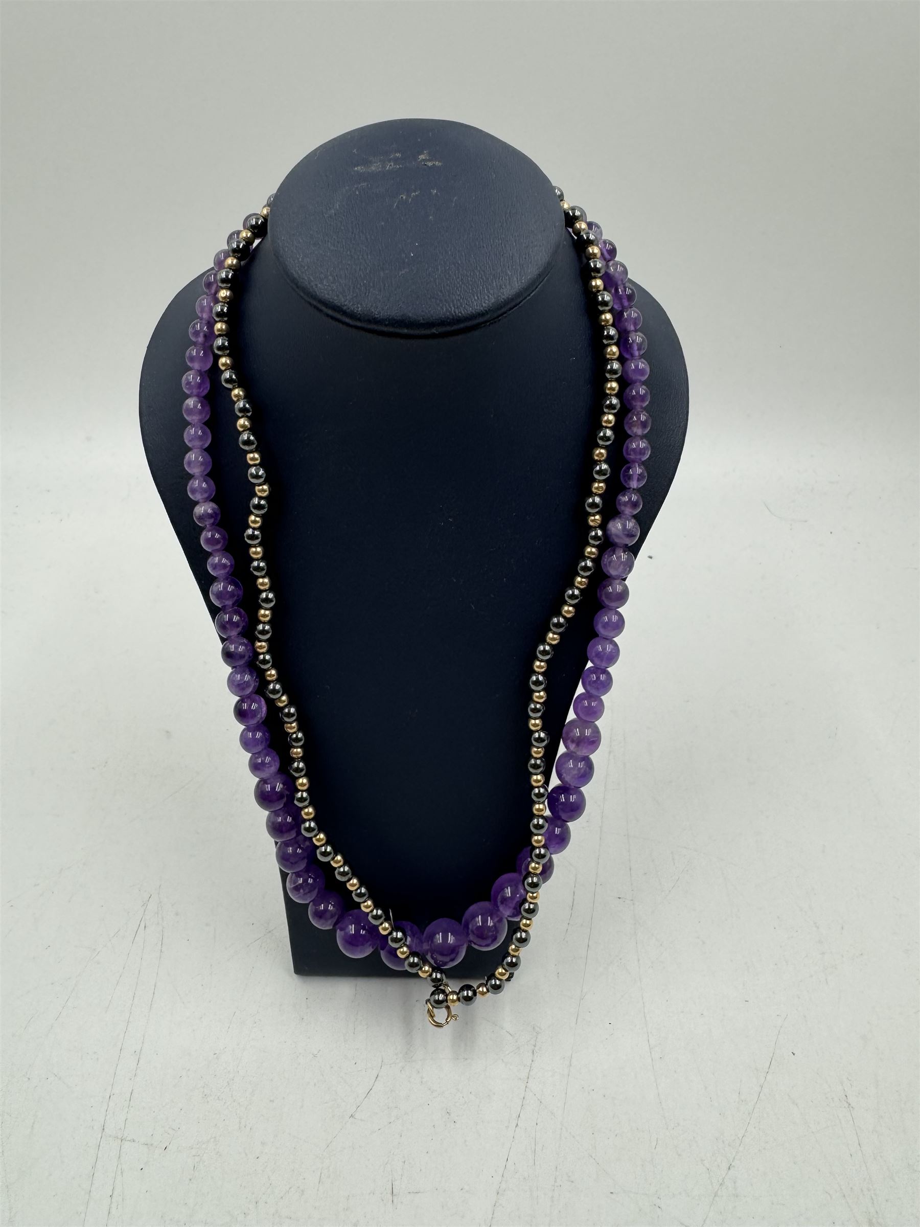 Amethyst bead necklace, with 9ct gold barrel clasp, together with a heamatite necklace with 9ct gold clasp, one other beaded necklace, silver charm bracelet, two silver bangles, silver buckle brooch and a 14ct gold filled wirework ring