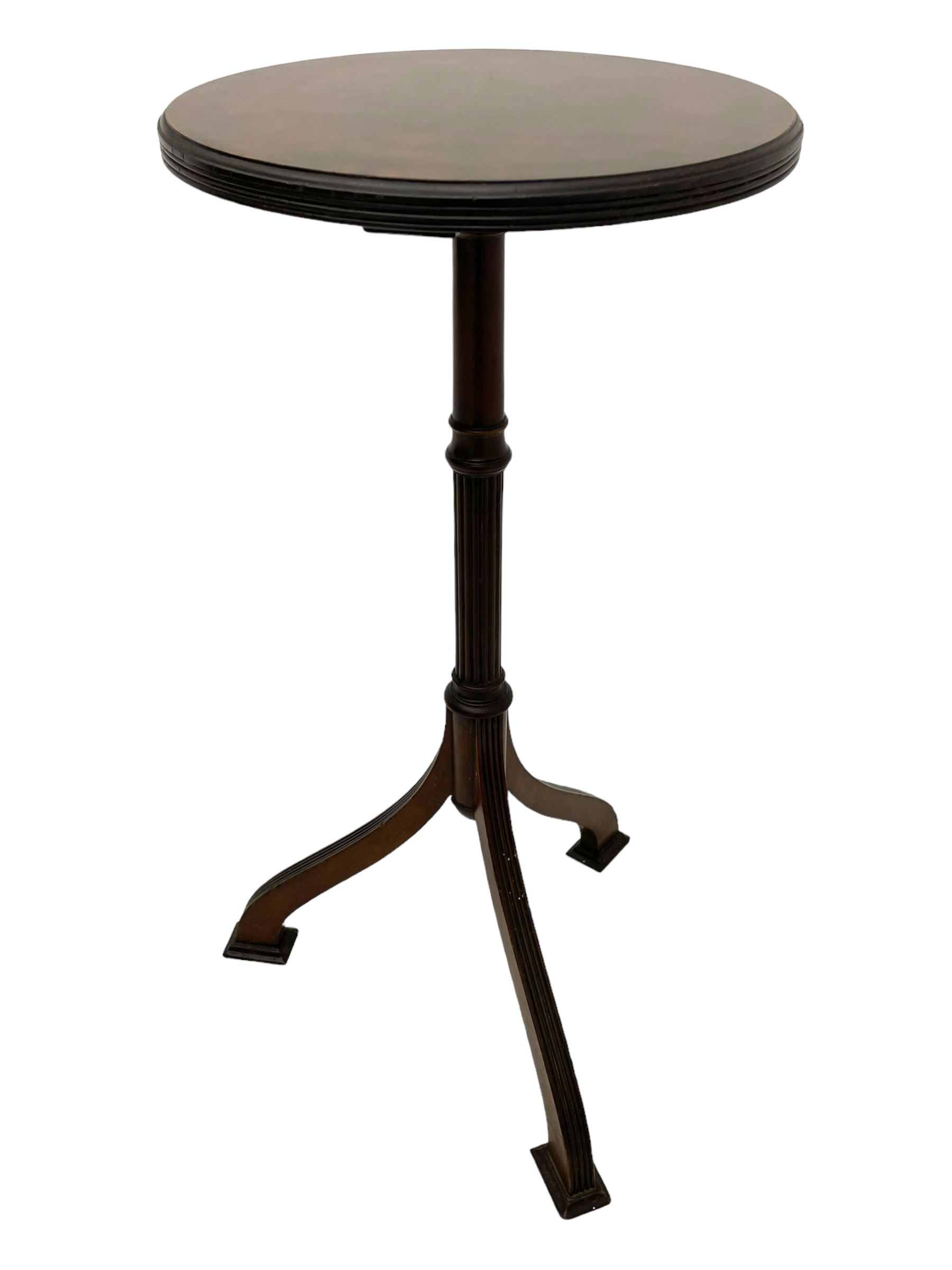 Early 20th century mahogany wine table, figured circular top with reeded edge, on turned and reed moulded stem, three reeded tapered supports on rectangular moulded pad feet 