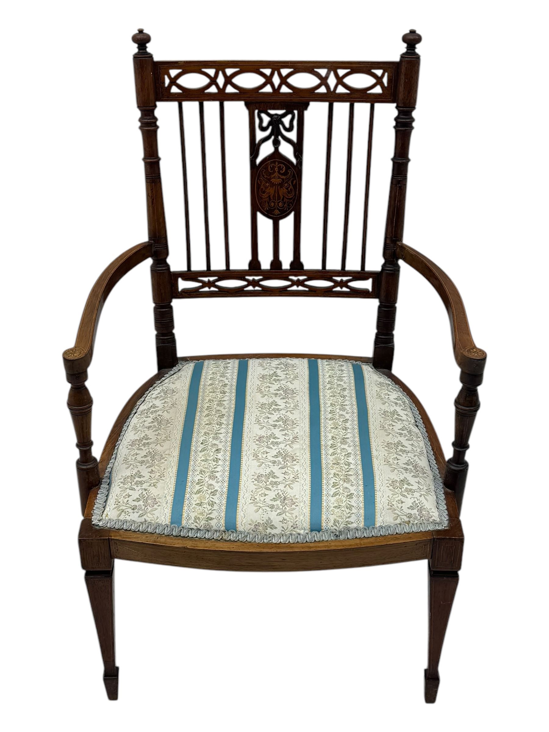 Edwardian inlaid rosewood elbow chair, pierced cresting rail over carved ribbon tie and oval inlaid panel, upholstered in stripe and floral pattern fabric, on square tapering supports with spade feet 