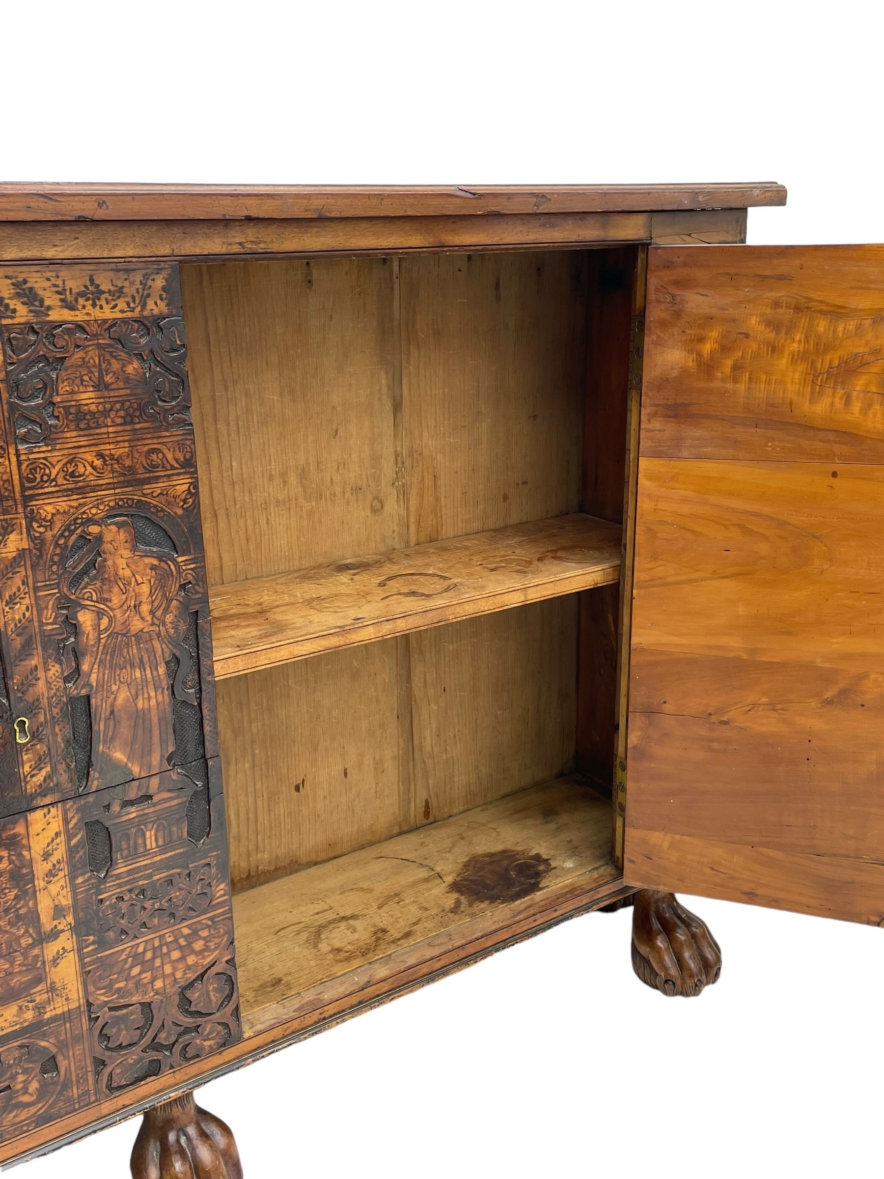 17th century and later cedarwood and pine side cupboard, moulded rectangular top, enclosed by two doors possibly removed and reused from a Venetian Cassone, carved and decorated with penwork, the upper architectural arcade with busts of noblemen, the larger decoration depicting hunters on horseback within woodland landscape with various animals, central and flanking uprights decorated with classical female figures upon pedestals, lower roundels decorated with lion and putto motifs, overall foliate decoration, raised on five hairy paw carved feet, the interior fitted with shelf