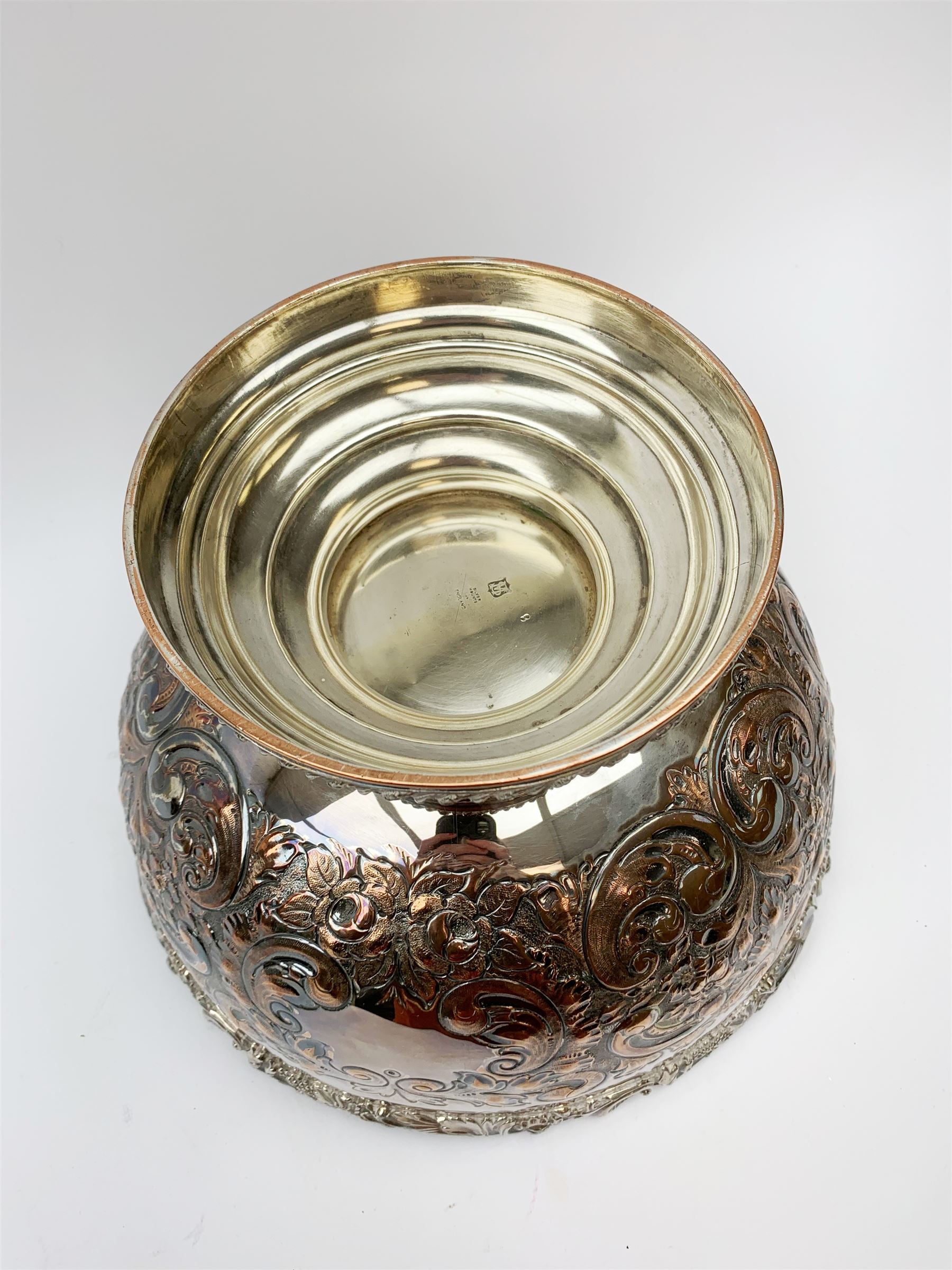 An early 20th century Barker Ellis Silver Co Ltd silver plated punch bowl, with embossed foliate detail to the body, applied rim with fruiting vines and acanthus leaves, and raised upon a stepped circular base with gadrooned detail, with MS shield mark beneath for Barker Ellis, H22c, D31cm. 