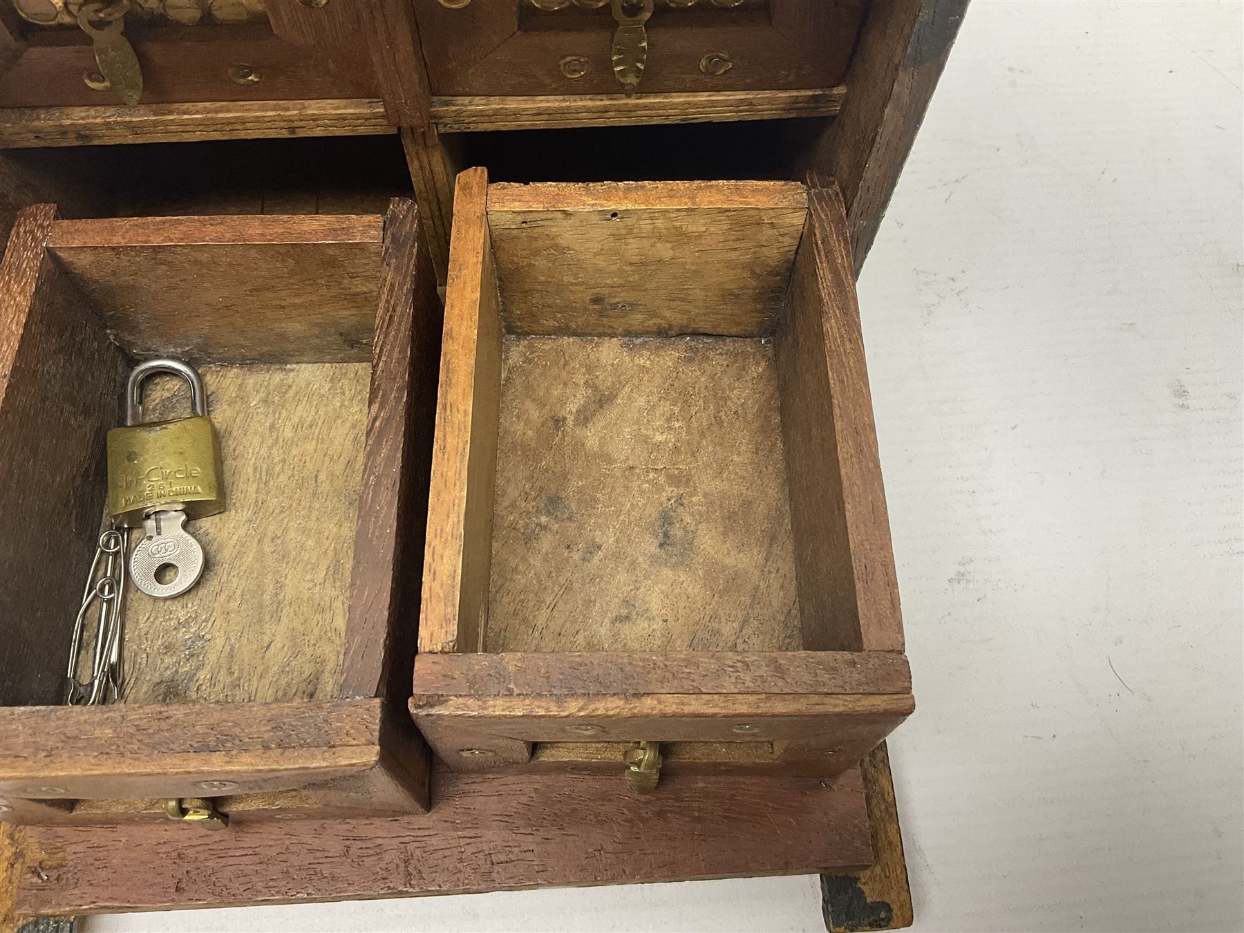 Small wooden collectors chest, painted to each side with birds upon a black ground within red and yellow borders, opening to reveal a compartmentalised interior containing one long drawer above two smaller drawers, H13cm, W18cm, D14.5cm