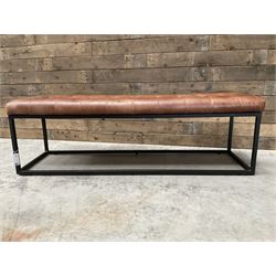 Two rectangular metal framed benches, upholstered in buttoned tan leather