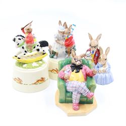 Two Royal Doulton Bunnykins music boxes, comprising Rocking Horse and Winter Waltz together with two Royal Doulton Bunnykins figures Once Upon a Time and Father, Mother & Victoria, all with original boxes  