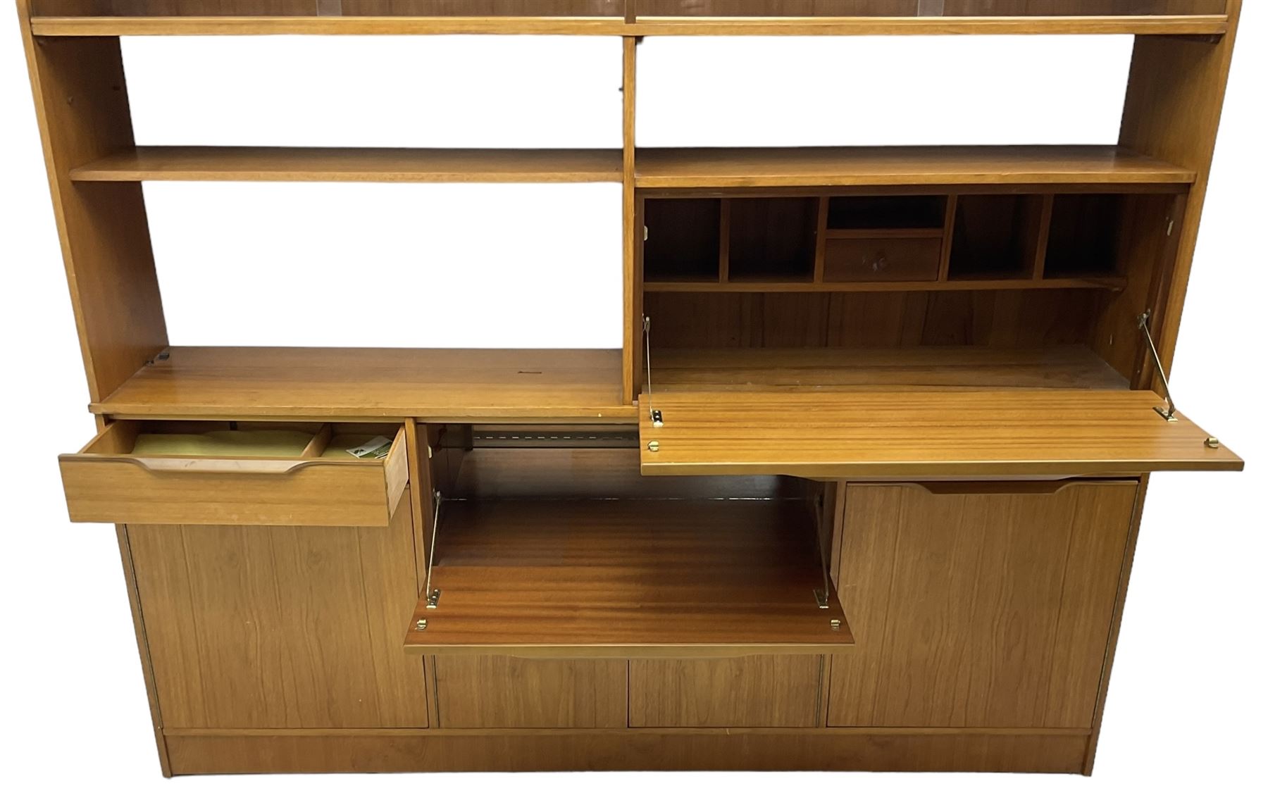 Mid-20th century teak sectional wall unit, combination of cupboards and drawers, raised sliding glass doors