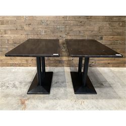 Two dark walnut rectangular console tables, on black metal bases