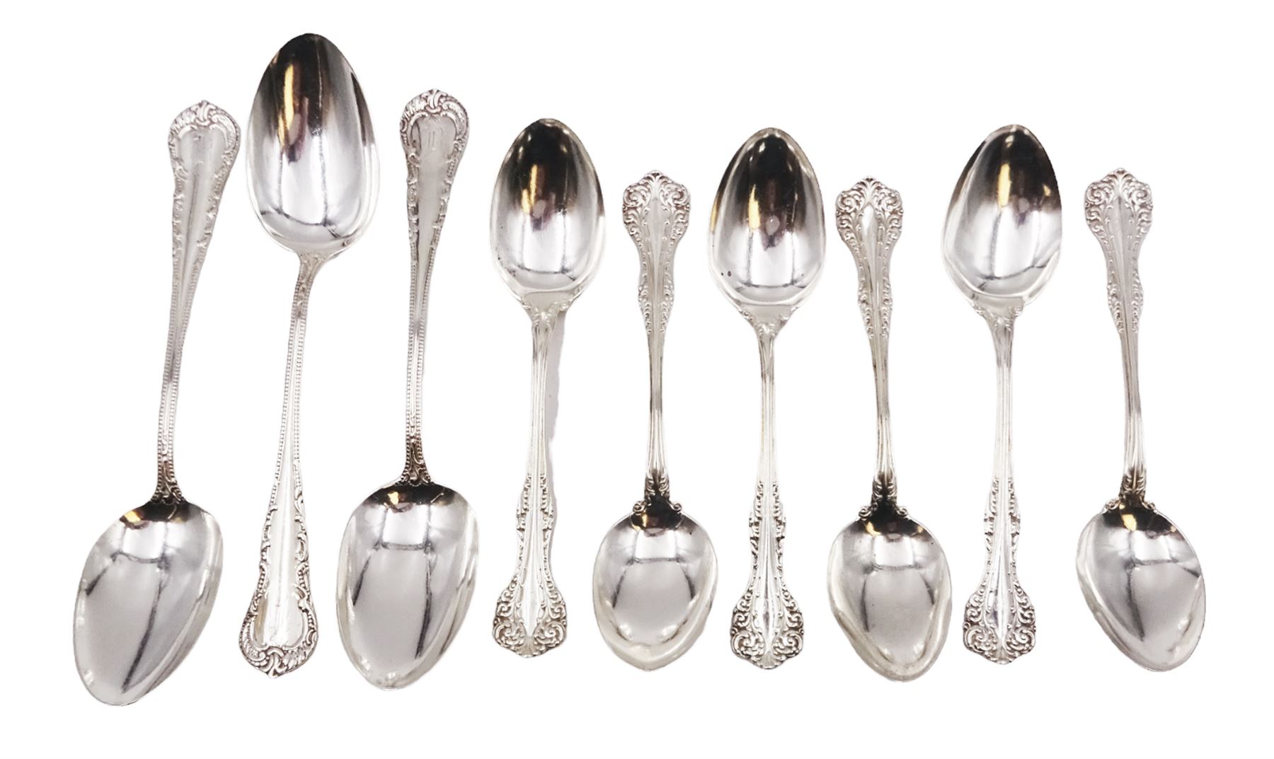 Group of American silver flatware, comprising set of three table spoons, each with beaded stem and engraved with initialsm marked for Mermod & Jaccard Jewelery Co. and a set of six American silver dessert spoons, each engraved with initial in a scrolling border, stamped Sterling