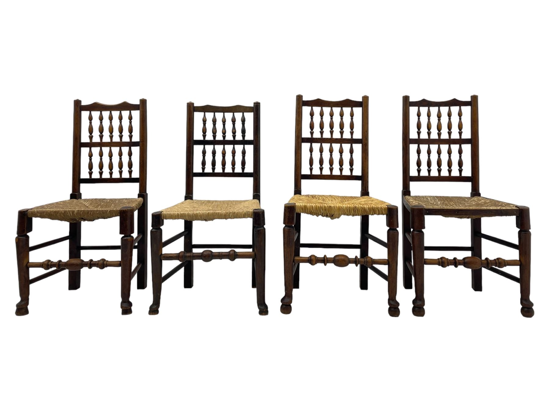 Matched set of twelve 19th century elm Lancashire spindleback dining chairs, shaped cresting rail over spindle back, rush seat, on turned supports united by turned stretchers, ring and globular turned front stretcher 